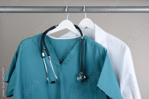 Scrubs with Stethoscope and Lab Coat on Hanger photo