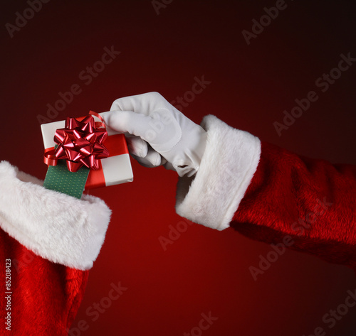 Santa Placing Small Gift Into Stocking