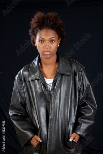 Thoughtful black woman in leather jacket