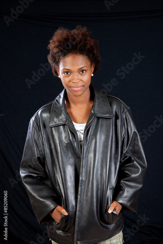 Black woman in black leather jacket, smiling