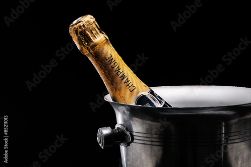 Champagne in bucket on black