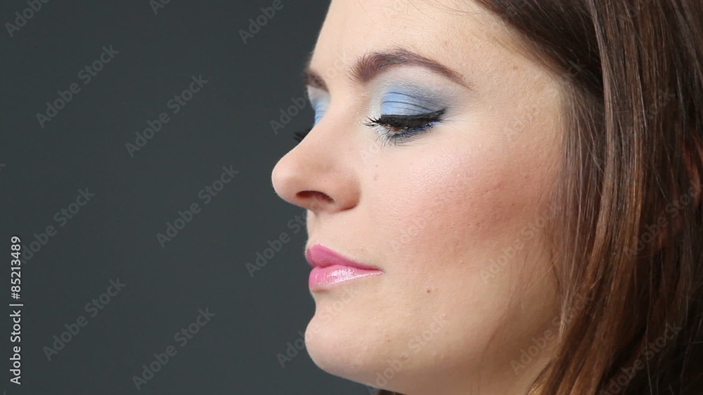 Makeup artist applying lip gloss to model lips, full HD