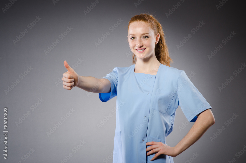 Young pretty nurse isolated on gray Young pretty nurse isolated on gray