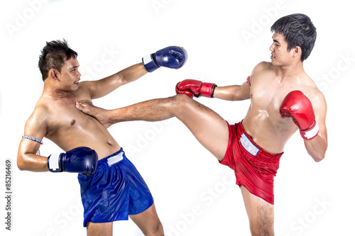 Two thai boxers exercising traditional martial art © kromkrathog