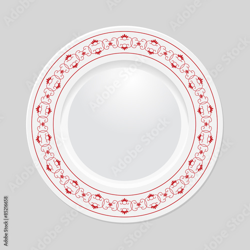 Decorative plate on gray background, top view