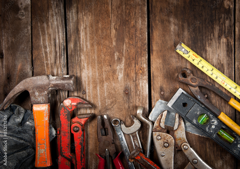 Set of different tools on wooden background Set of different tools on wooden background