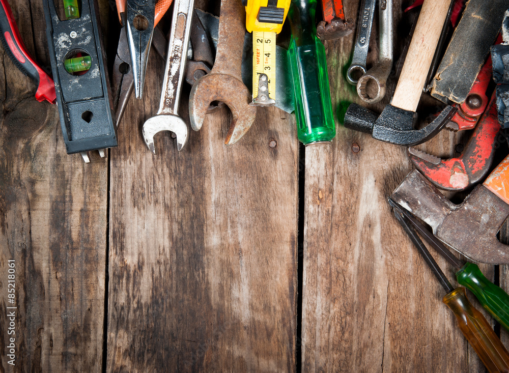 Set of different tools on wooden background Set of different tools on wooden background