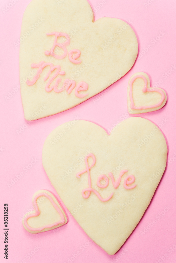 Valentine's Day Sugar Cookies on pink background. 
