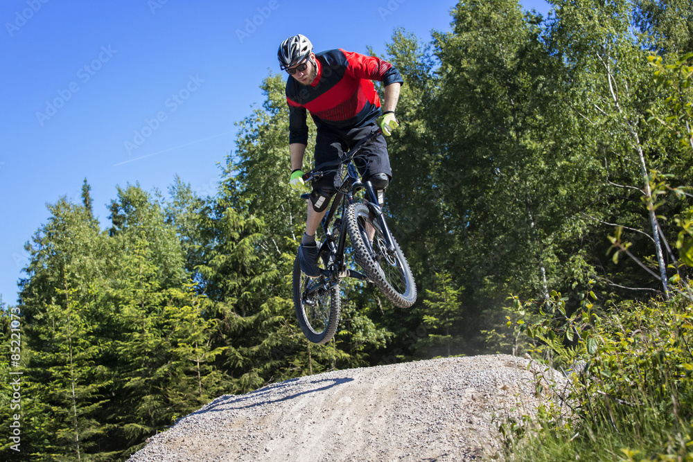 Mountain bike rider jumping kicker