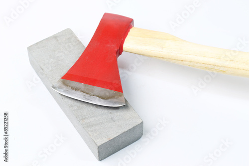 Stone sharpening an ax on a white background.