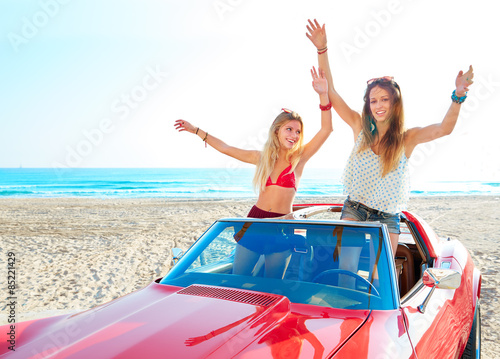 Beautiful party friend girls dancing in a car on the beach © lunamarina