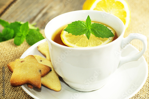 Cup of tea with slice of lemon and home made cookies. Selective focus