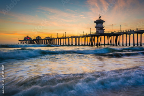 Waves in the Pacific Ocean and the pier at sunset  in Huntington