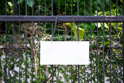 Empty sign over a metallic fence photo