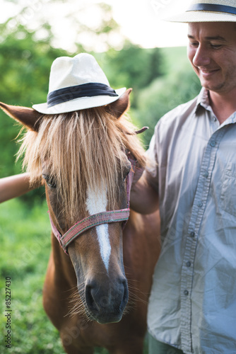 Horse and man in panama hat