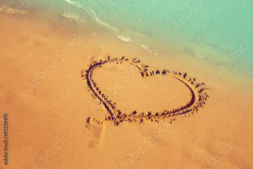 inscription heart on beach sand