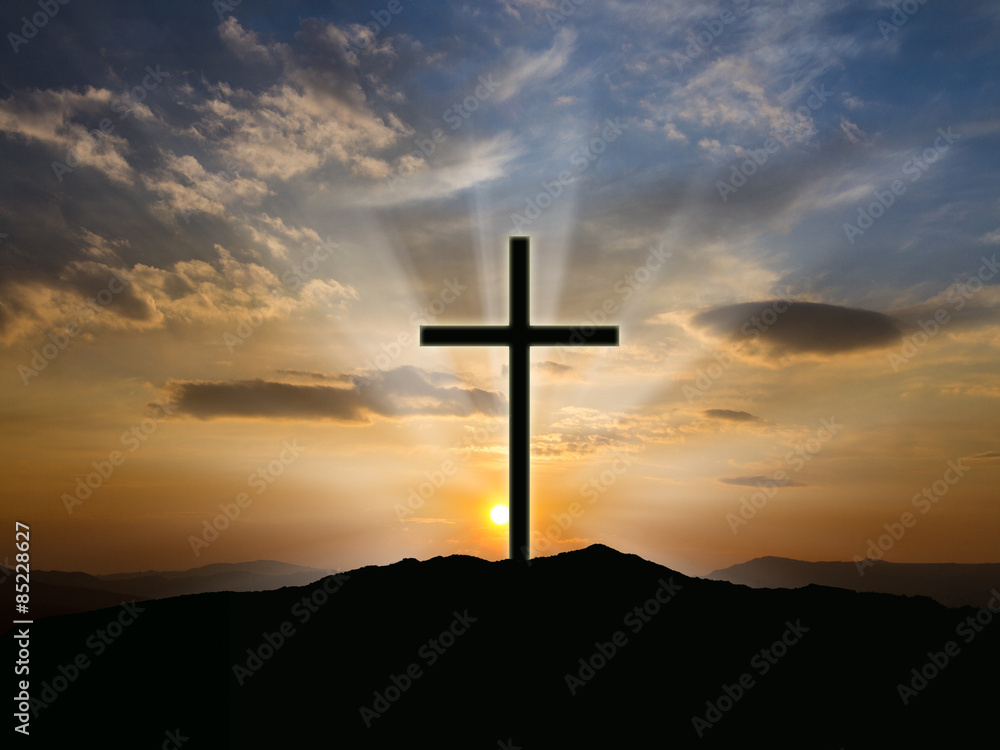 Silhouette of crosses at  sunrise or sunset with light rays.