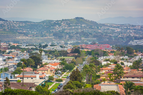 View of distant hills and houses from Hilltop Park in Dana Point © jonbilous