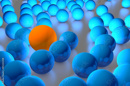 Many blue balls among which the orange stands out. 3D render