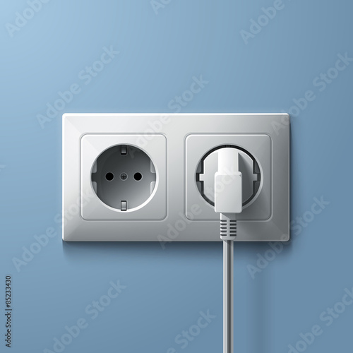 Electric white plug and socket on blue wall background
