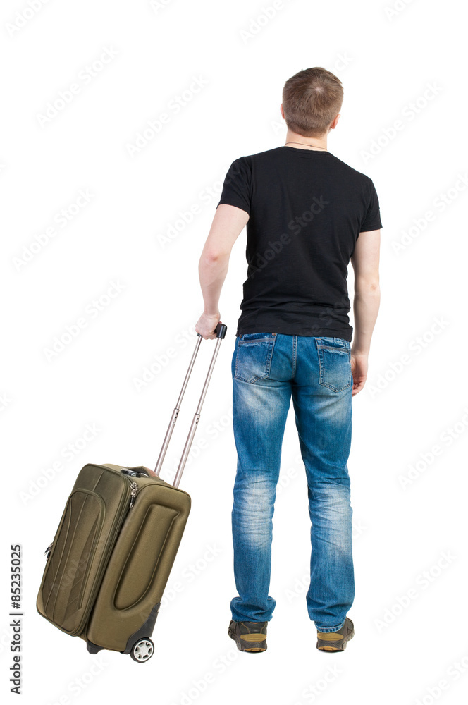 Back view of man with green suitcase looking up. Back view of man with green suitcase looking up.