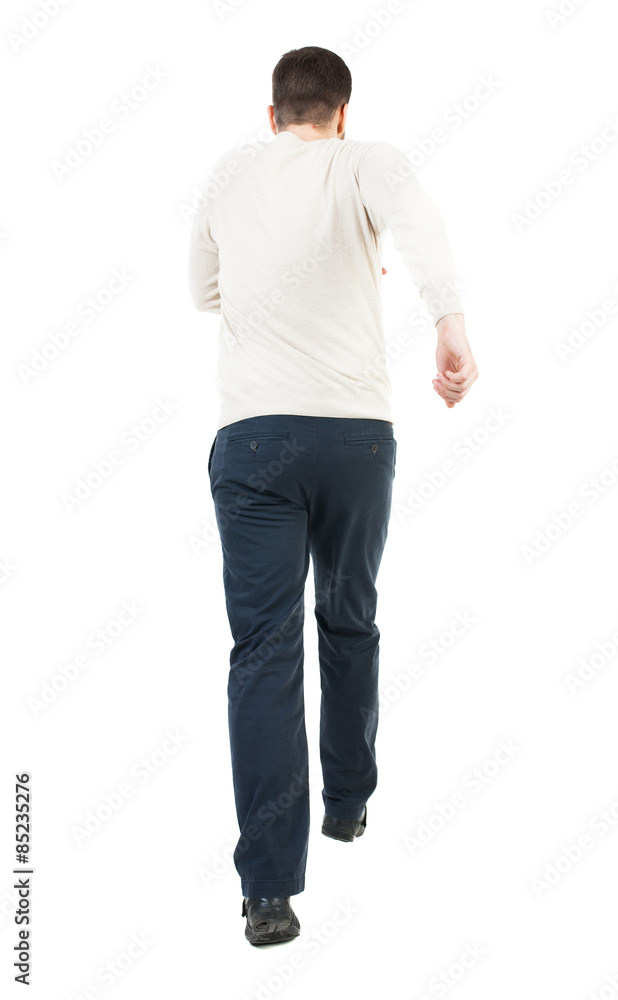 Back view of running man. Walking guy in motion. Back view of running man. Walking guy in motion.