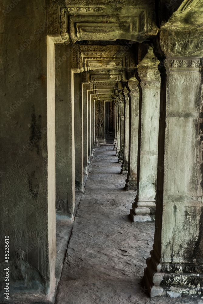 sight in perspective of a gallery and pillars in the archaeological place of angkor wat in siam reap, cambodia
