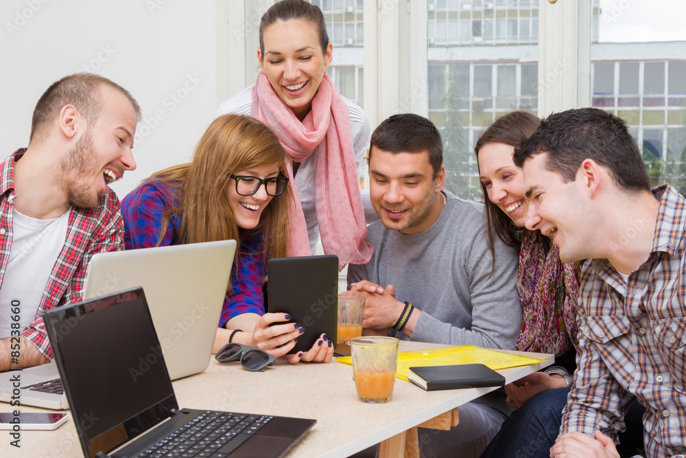 Young group of people discussing business plans. Young group of people discussing business plans.
