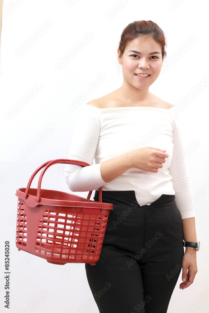Beautiful young woman shopping in a grocery store/supermarket/market and holding basket on white background Beautiful young woman shopping in a grocery store/supermarket/market and holding basket on white background