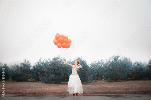 unusual woman with balloons as concept outdoors