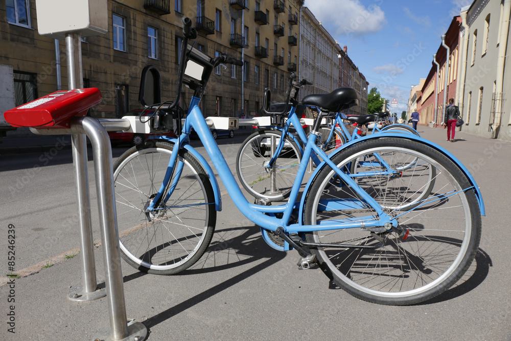 city bicycles for rent stand on a parking 