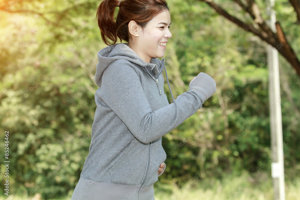 Running woman. Female runner jogging during outdoor on road .Young mixed race girl jogging in fall colors. Running woman. Female runner jogging during outdoor on road .Young mixed race girl jogging in fall colors.