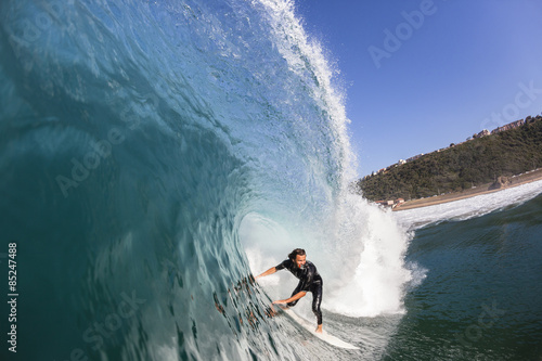 Surfing Surfer rides Inside Large Blue Hollow crashing ocean wave swimming photo action