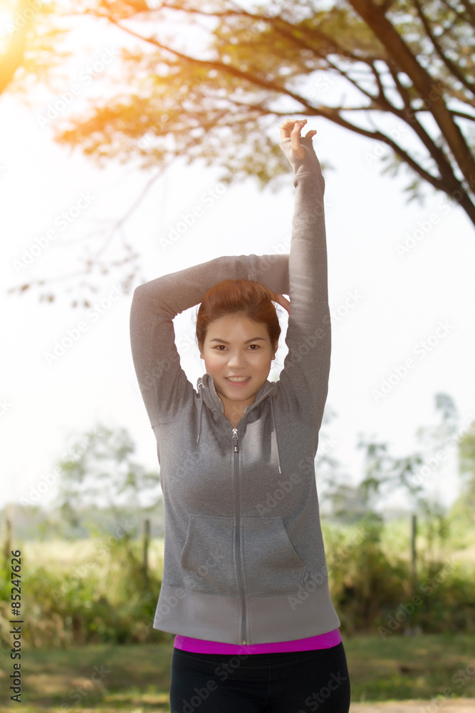 Athletic woman asia warming up and Young female athlete sitting on an exercising and stretching in a park healthy lifestyle concept. Athletic woman asia warming up and Young female athlete sitting on an exercising and stretching in a park healthy lifestyle concept.