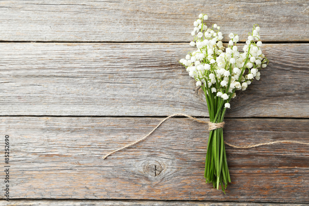 Obraz premium Lily of the Valley on grey wooden background