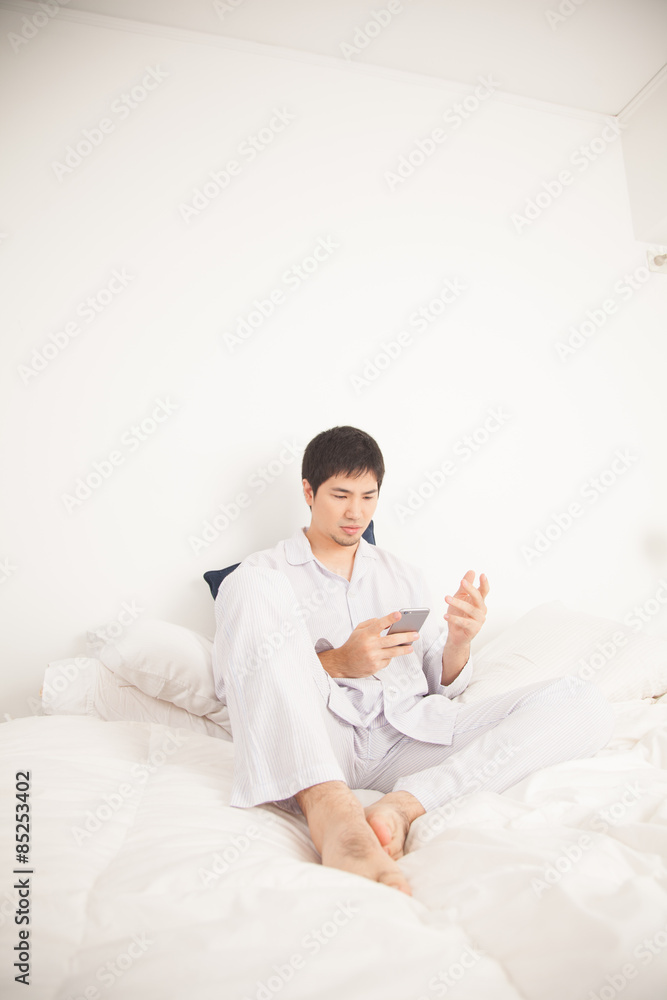 Man writing by phone Man writing by phone