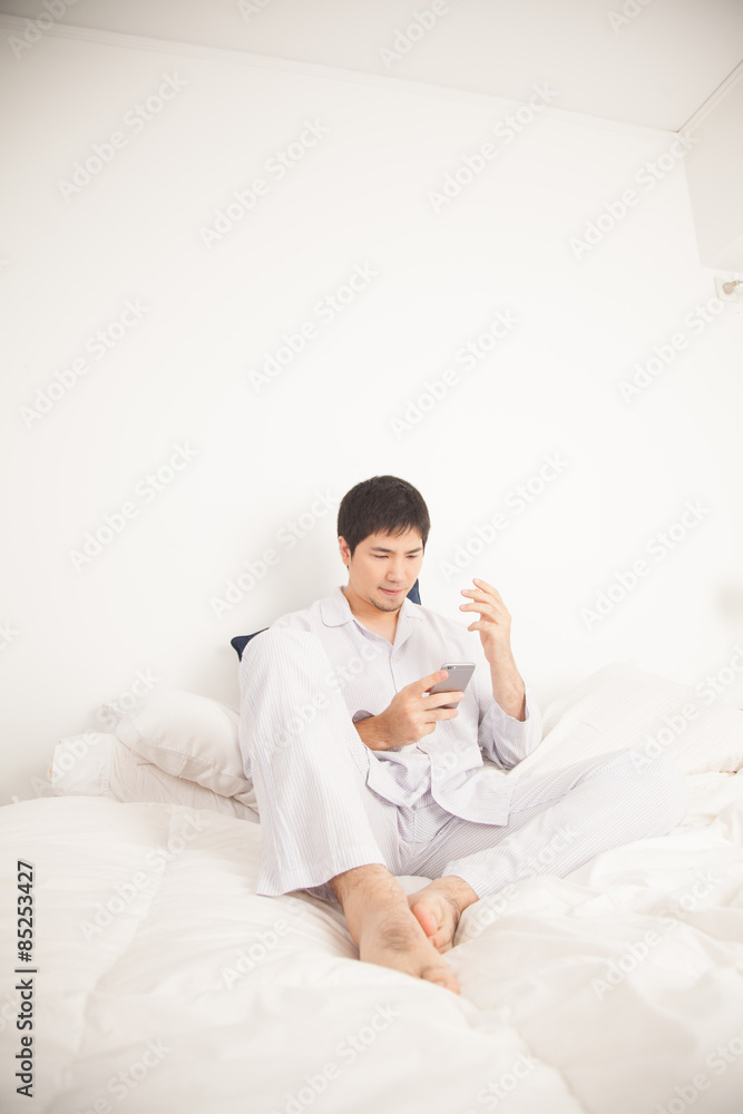 Man writing by phone Man writing by phone