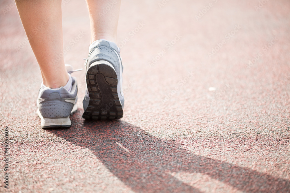 Runner athlete feet running on road Runner athlete feet running on road