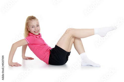 teenage girl is sitting on the floor 