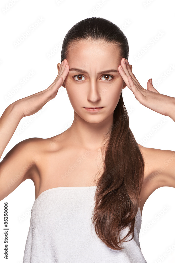 Fototapeta premium Beautiful young woman with headache touching her temples