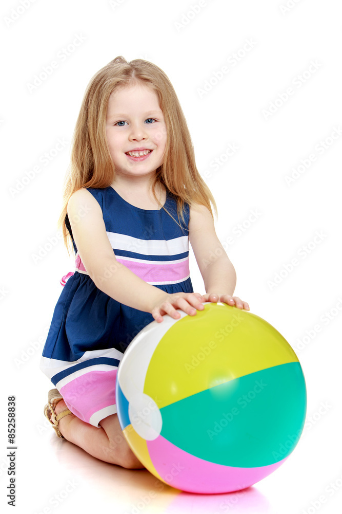 Beautiful little blonde girl with a large inflatable ball Beautiful little blonde girl with a large inflatable ball