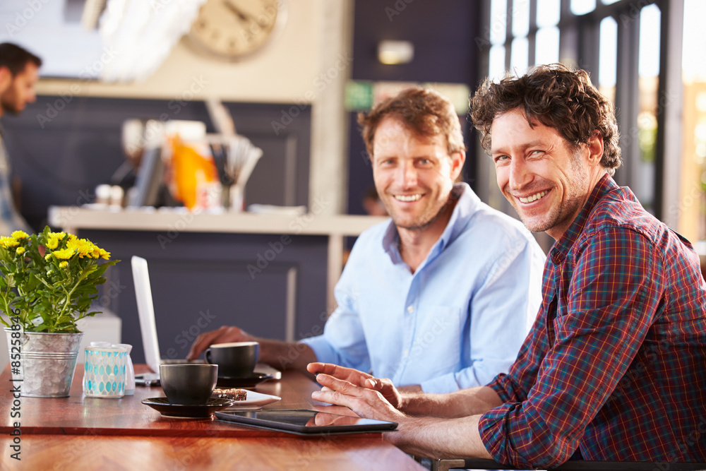 Two men meeting at a coffee shop, portrait Two men meeting at a coffee shop, portrait