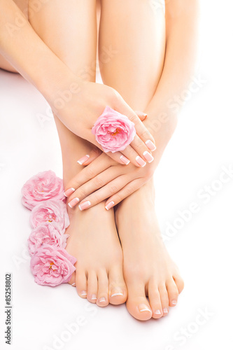 Fototapeta Naklejka Na Ścianę i Meble -  Relaxing pedicure and manicure with a pink rose flower