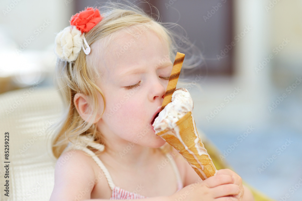 Adorable little girl eating ice cream Adorable little girl eating ice cream