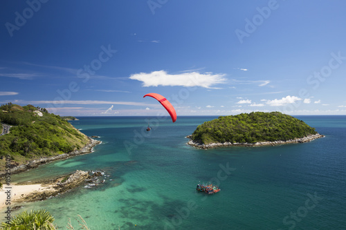 Sail of a paraglider in a blue sky over the sea