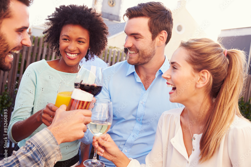 Group of friends drinking at a rooftop bar Group of friends drinking at a rooftop bar
