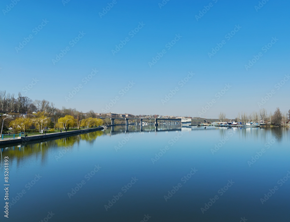 deep blue sky over river with bridge