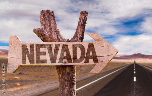 Nevada wooden sign with desert road background photo