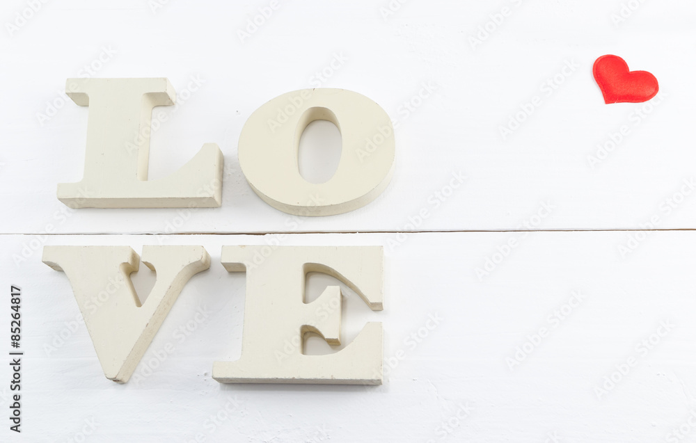 Wooden letters forming word love written on white wooden background Wooden letters forming word love written on white wooden background
