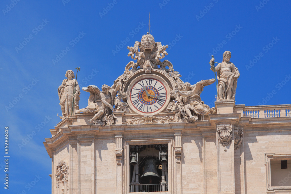 Hours and bell on St. Peter's Cathedral facade. Vatican, Rome, Italy